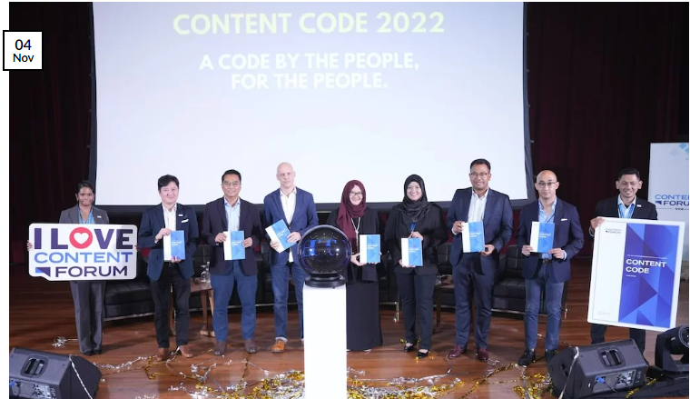 Content Code Launch panellists and Executive Director holding copies of the Content Code and foamboards.